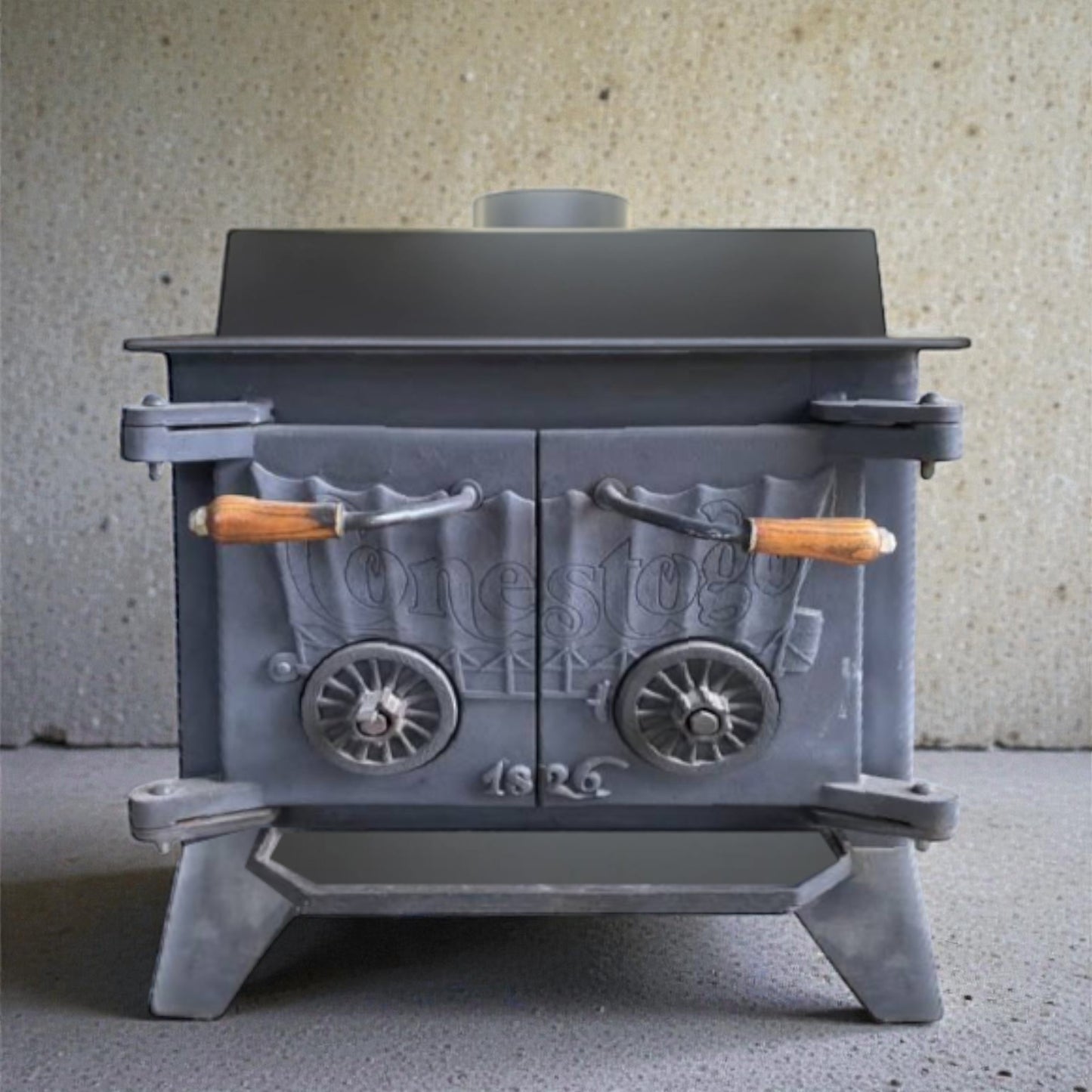 Vintage Conestogo gray metal stove with wooden handles on a neutral background