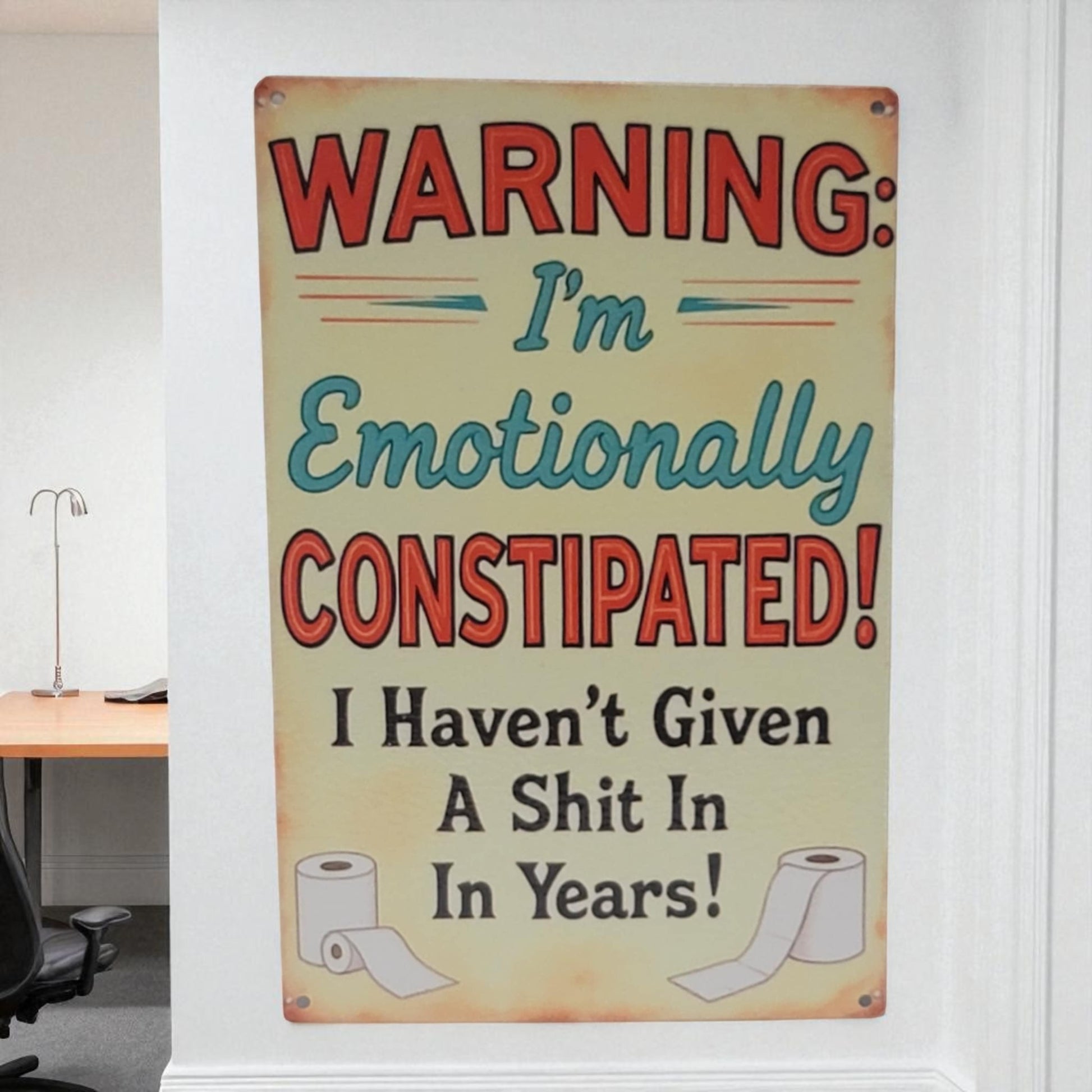 Humorous sign warning of emotional constipation in a room setting