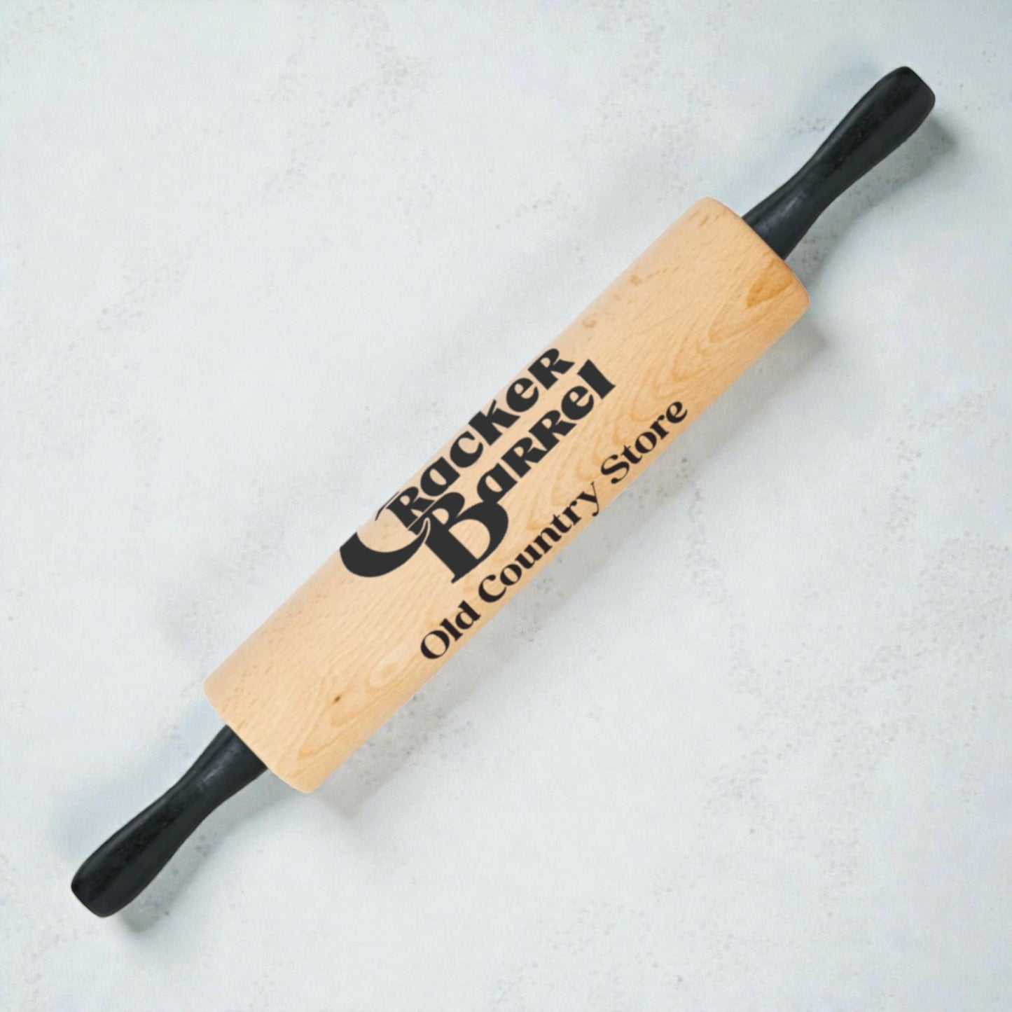 Wooden rolling pin with Cracker Barrel logo on a light background