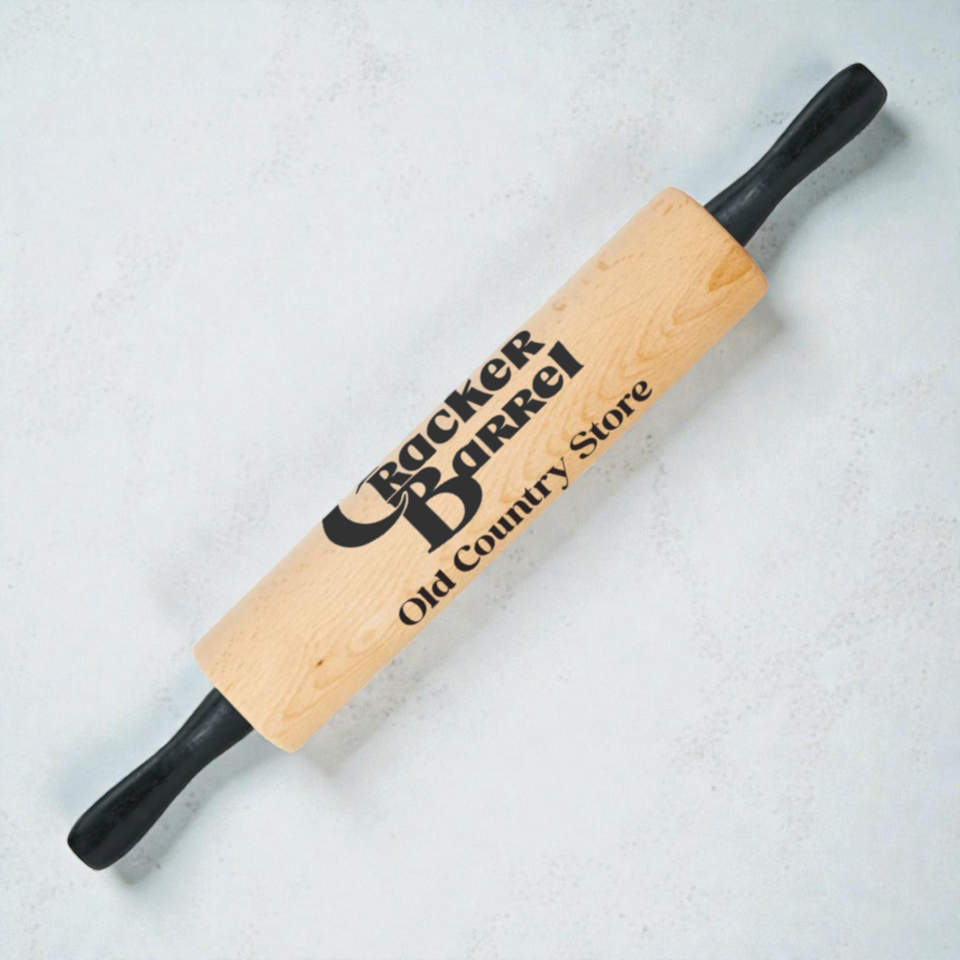 Wooden rolling pin with Cracker Barrel logo on a light background