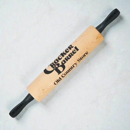Wooden rolling pin with Cracker Barrel logo on a light background