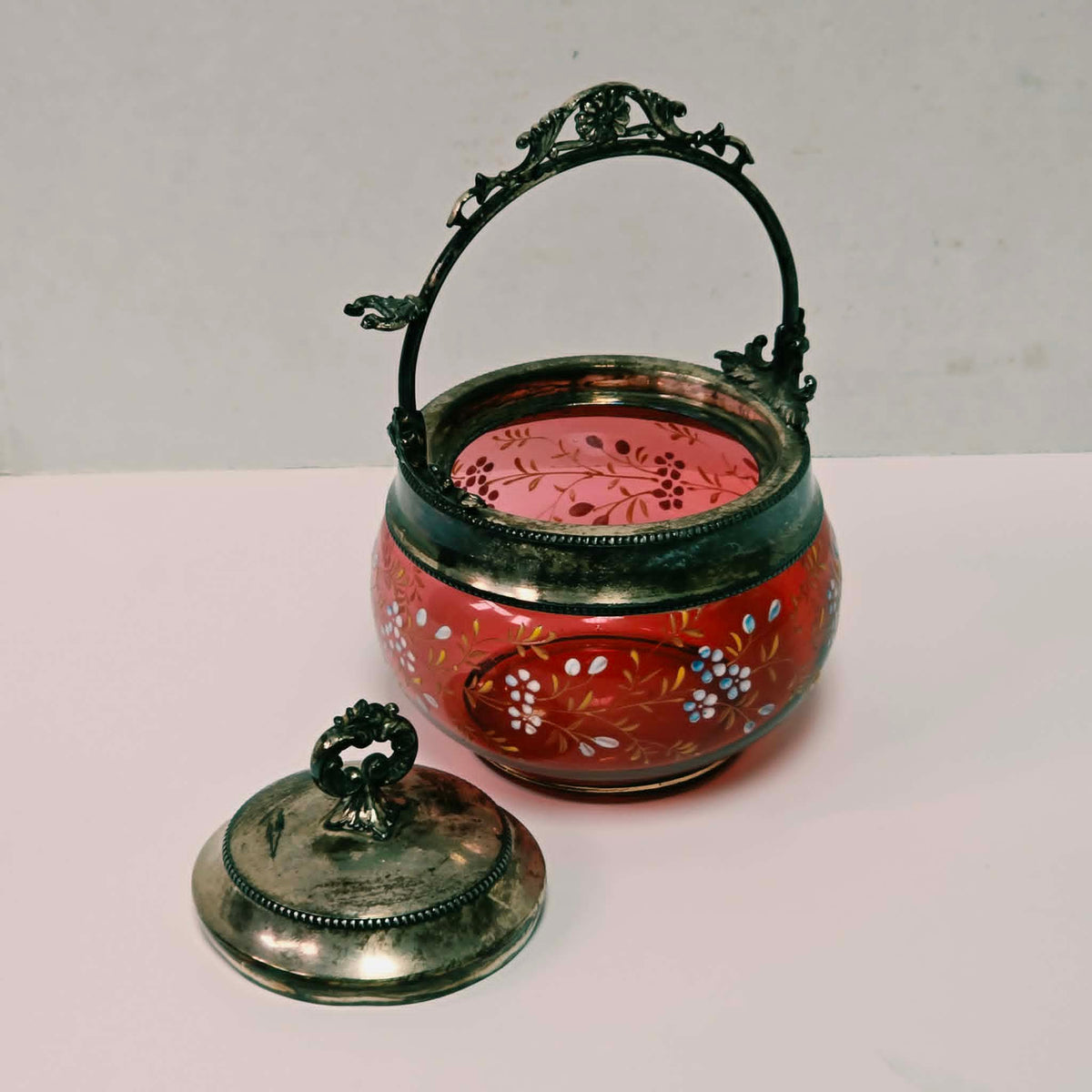 Victorian cranberry glass pickle caster sugar bowl with hand-painted floral decoration and silver holder
