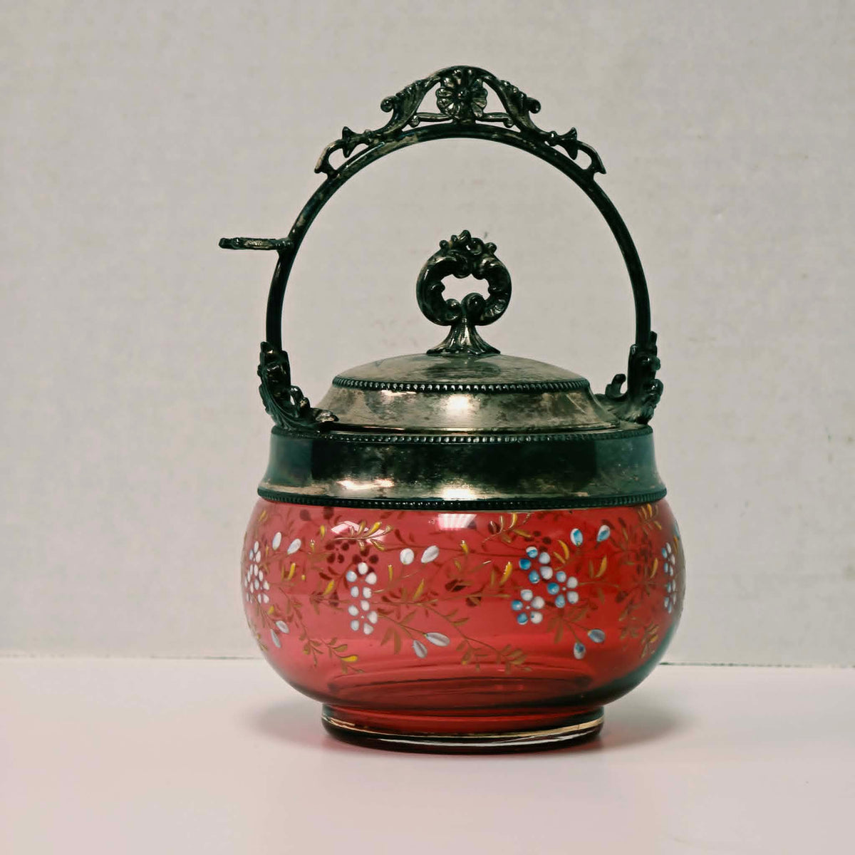 Victorian cranberry glass pickle caster sugar bowl with hand-painted floral decoration and silver holder
