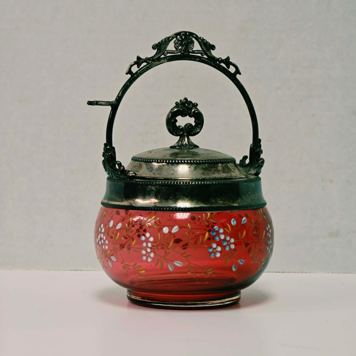 Victorian cranberry glass pickle caster sugar bowl with hand-painted floral decoration and silver holder
