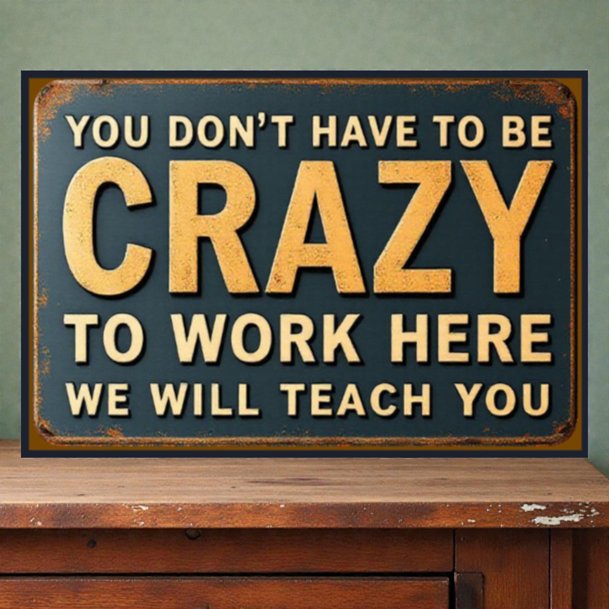 Vintage-style sign with motivational text on a wooden surface and green wall background