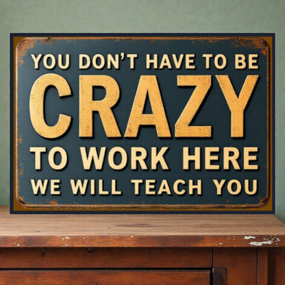Vintage-style sign with motivational text on a wooden surface and green wall background