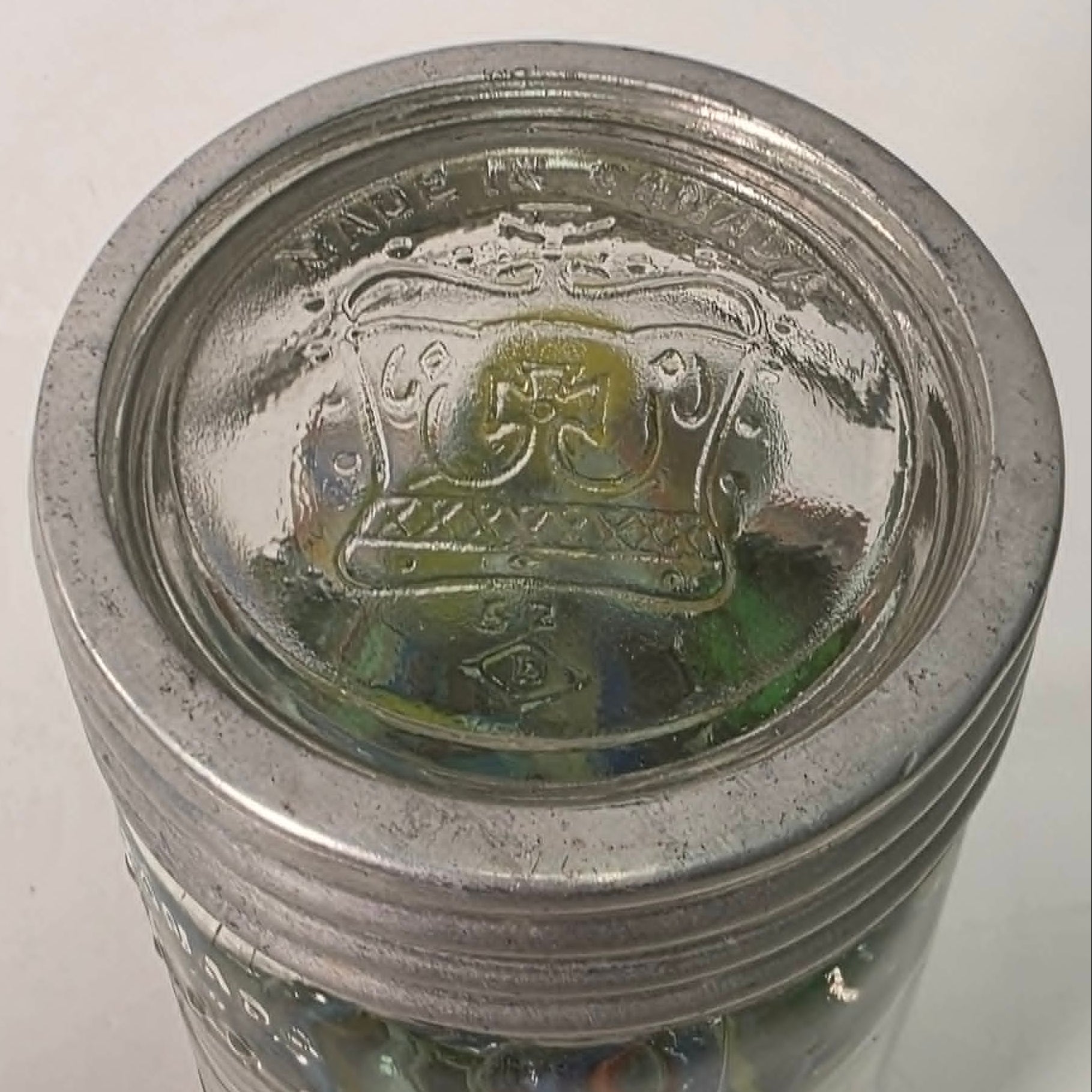 Antique Crown Sealer jar packed with unsorted vintage marbles collected over the years.