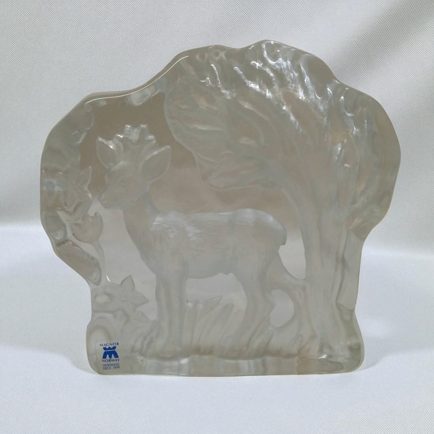 Clear glass sculpture of a buffalo on a white background