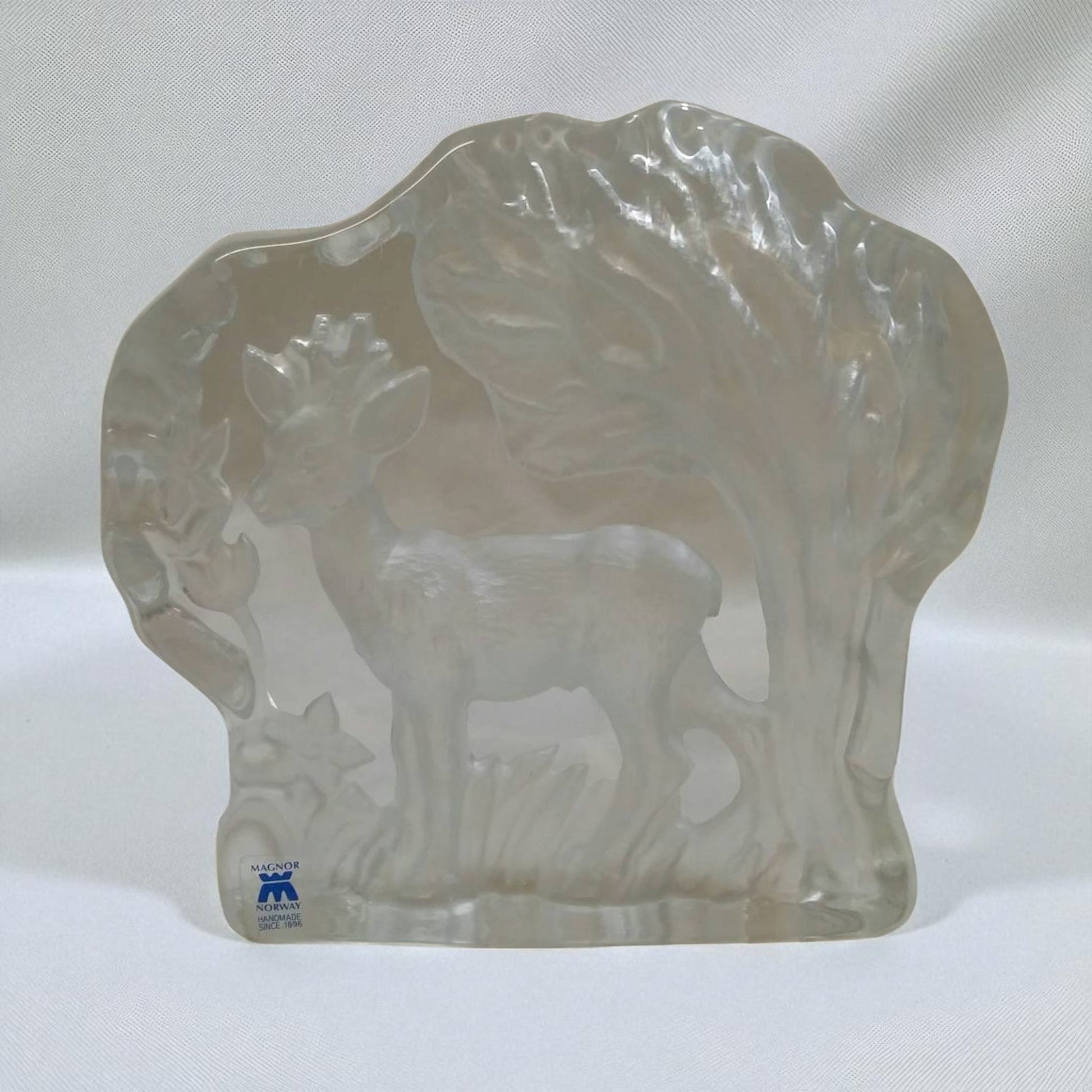Clear glass sculpture of a buffalo on a white background