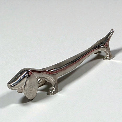 Metallic dachshund figurine on a white background