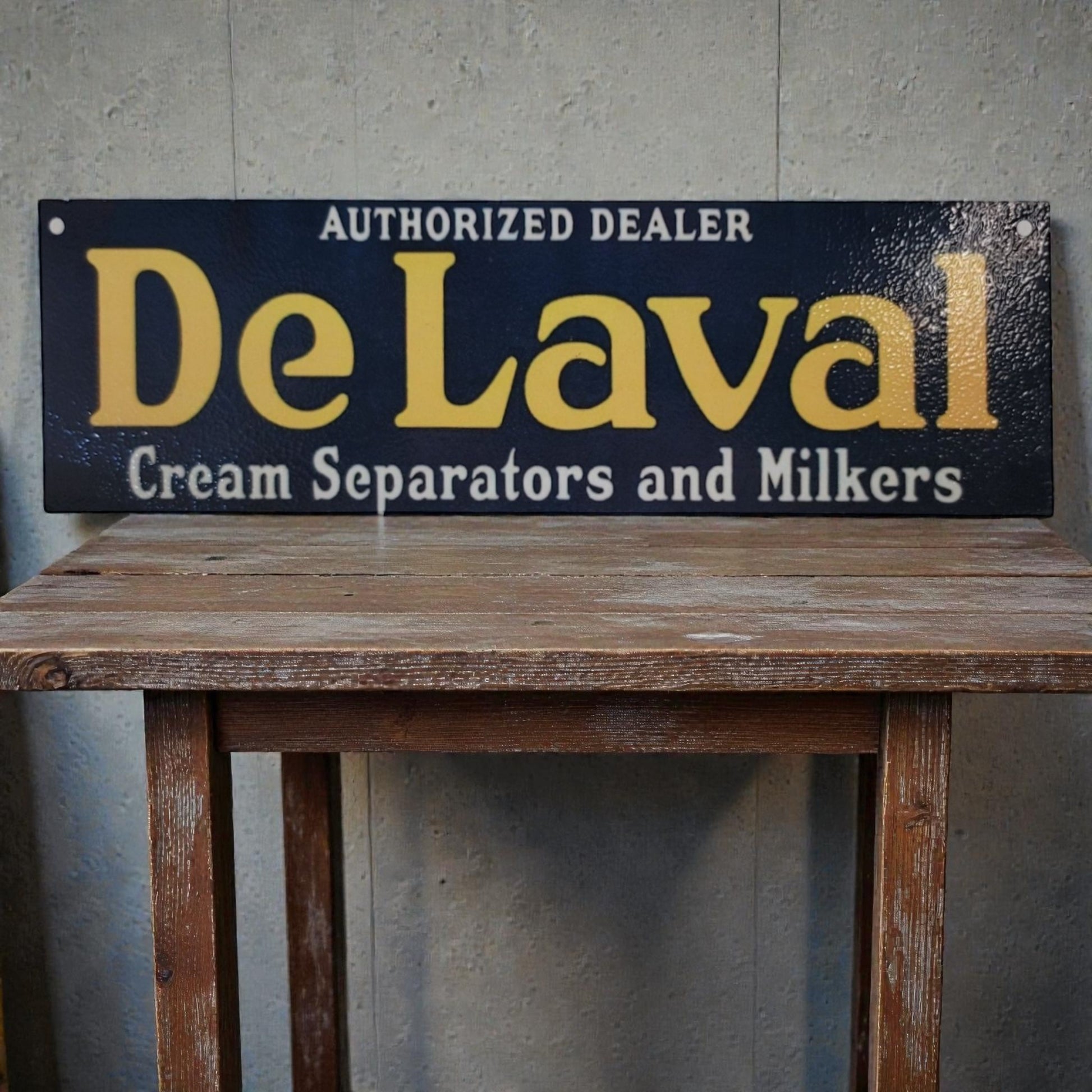 Vintage-style sign for DeLaval cream separators and milkers on a wooden table.