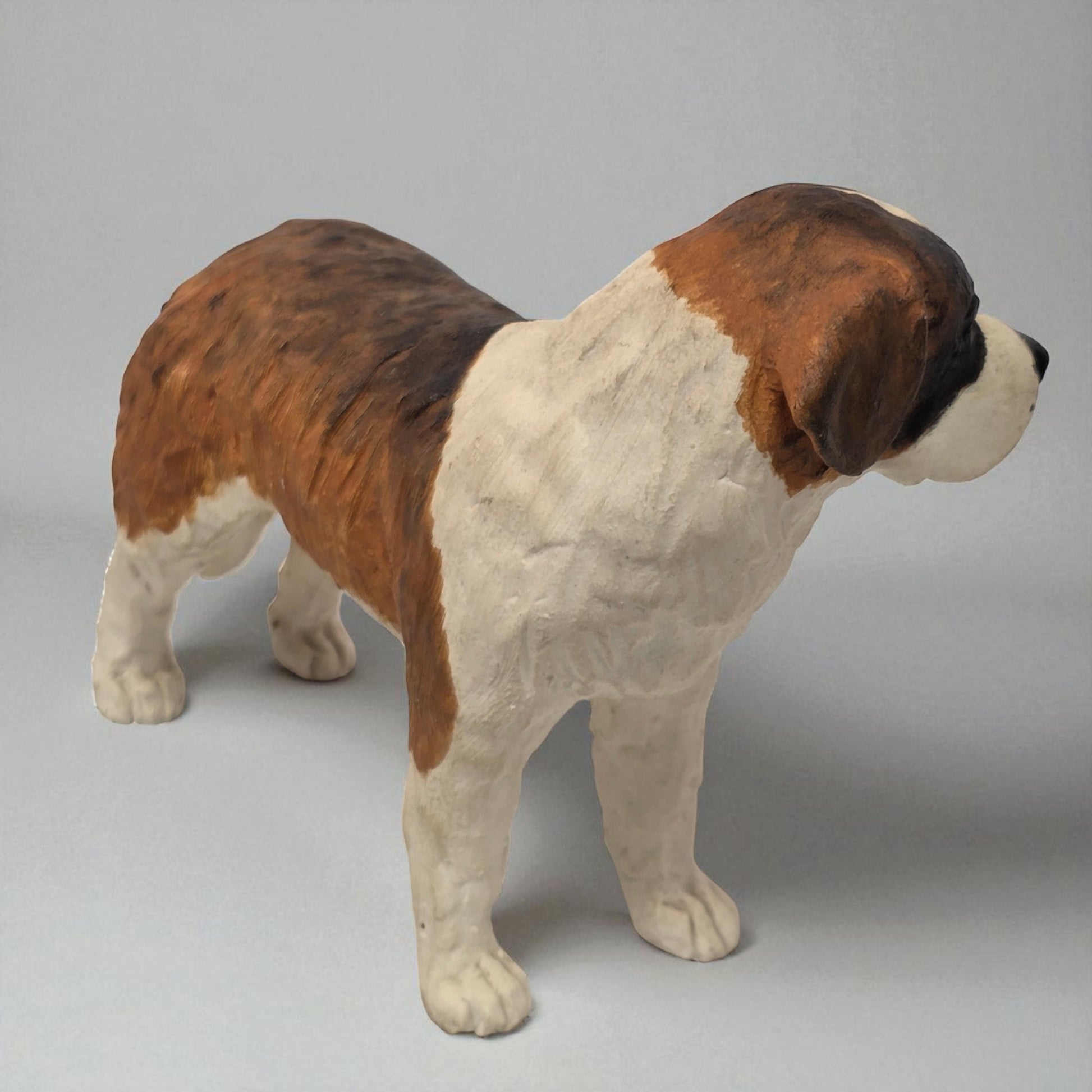 Stuffed toy of a Saint Bernard dog on a gray background