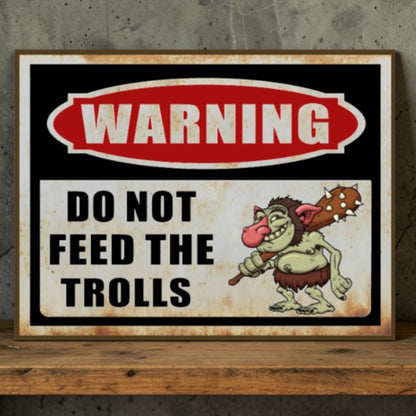 Vintage-style warning sign with cartoon troll and text 'Do Not Feed the Trolls' on a wooden surface.