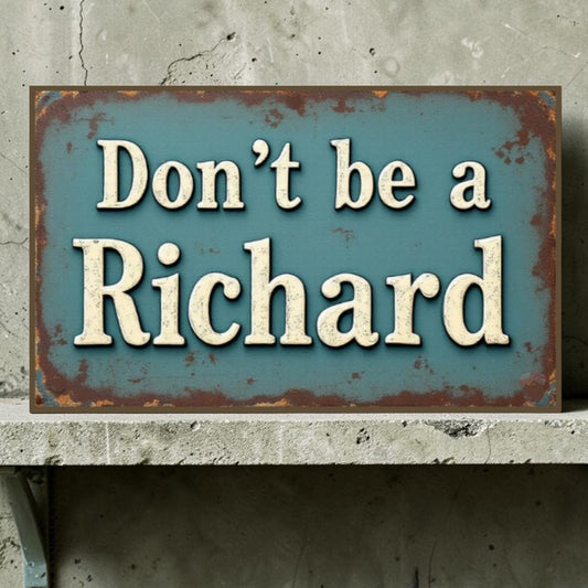Rustic metal sign with text 'Don't be a Richard' on a concrete surface.