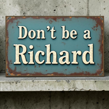 Rustic metal sign with text 'Don't be a Richard' against a concrete wall.