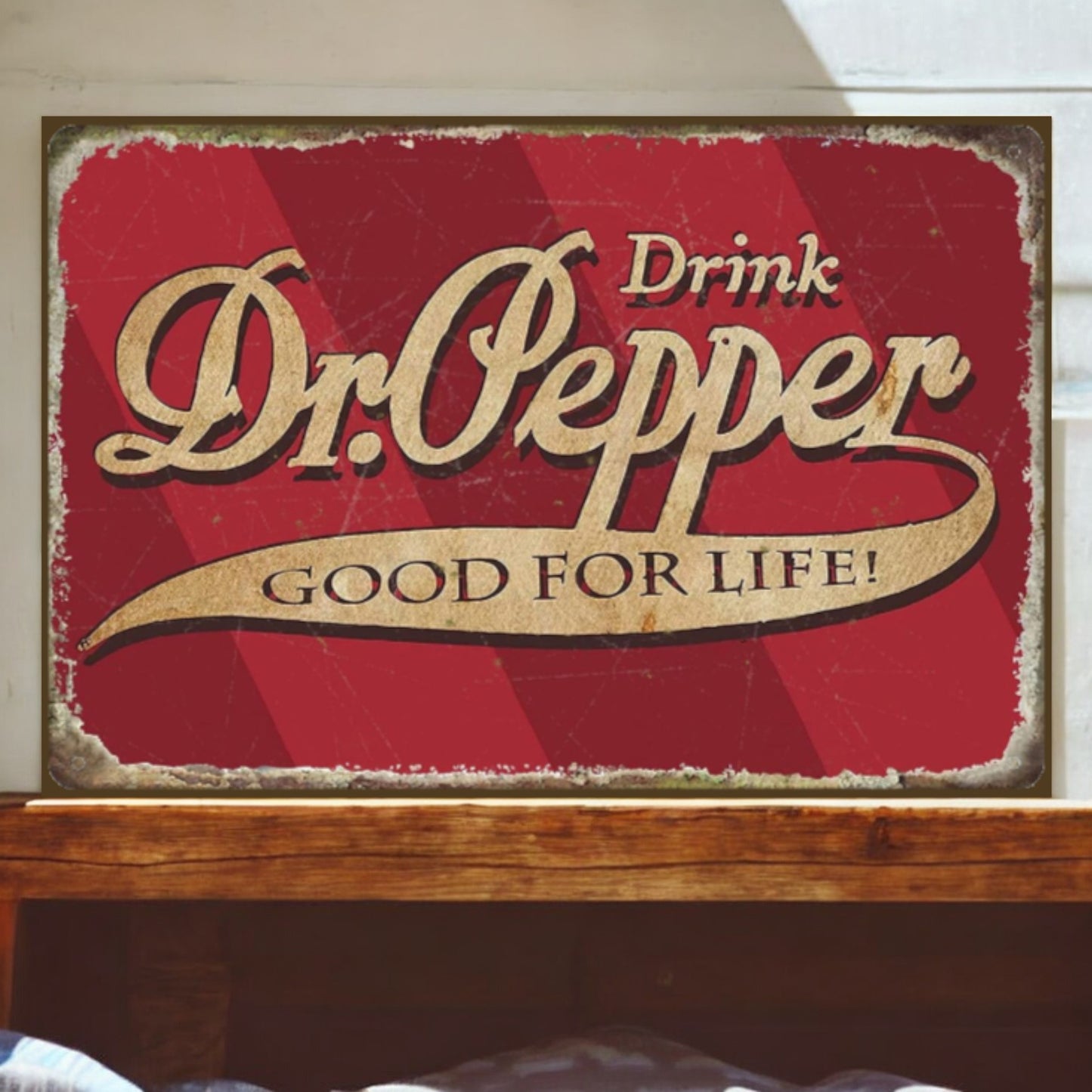 Vintage-style Dr. Pepper sign on a wooden surface with a white wall background