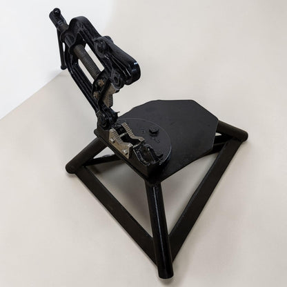 Erie Tools heavy duty pipe vise mounted on stand used for industrial plumbing and pipe clamping work.
