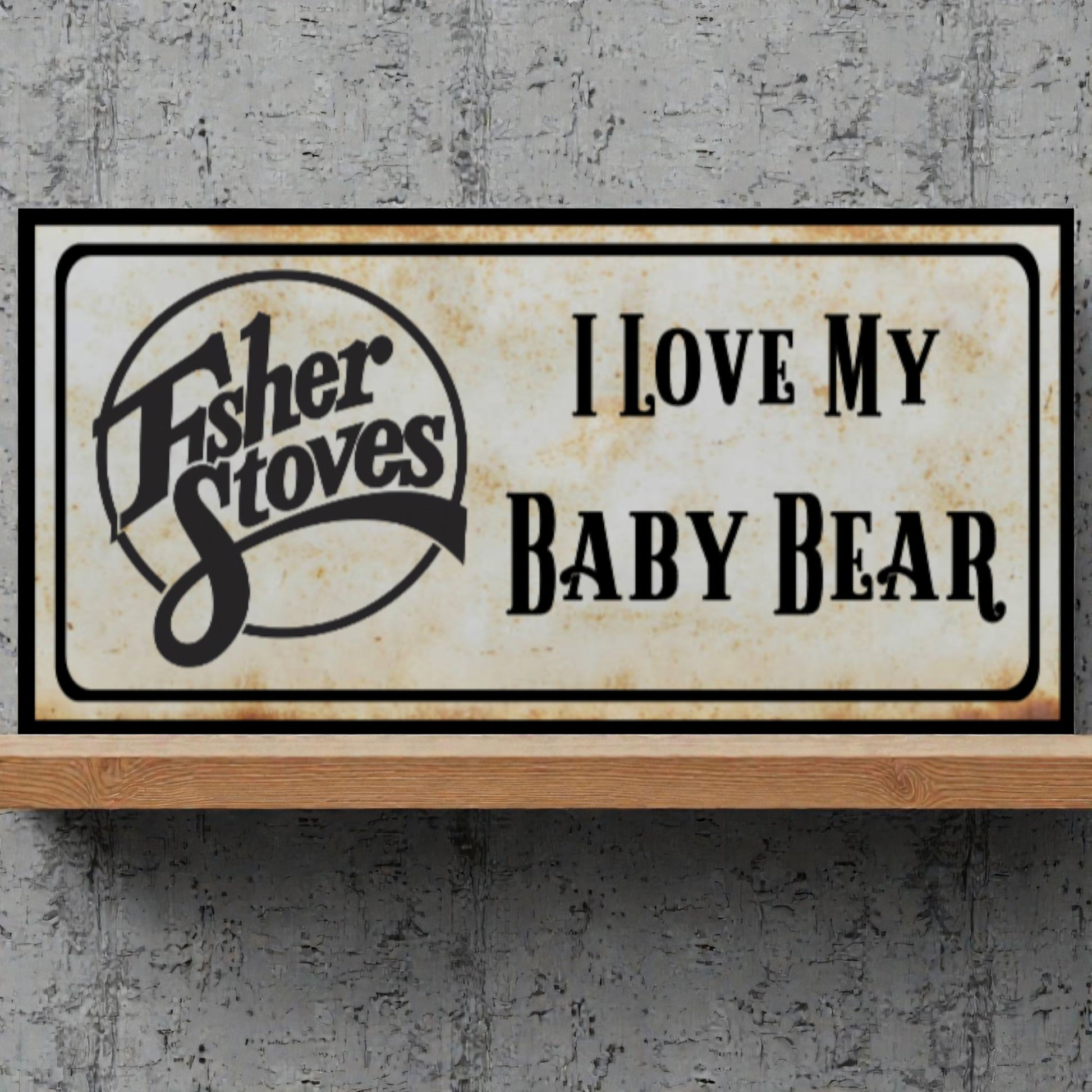 Fisher Stoves sign with 'I Love My Baby Bear' text on a textured gray background