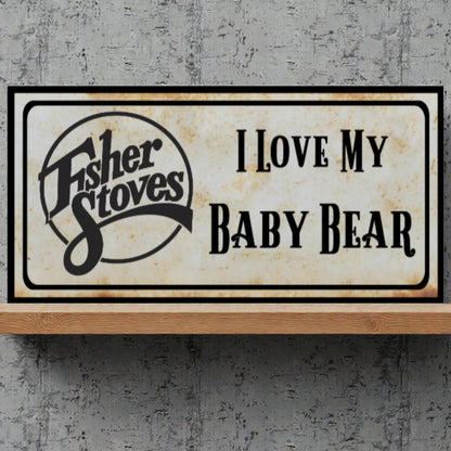 Fisher Stoves sign with 'I Love My Baby Bear' text on a textured gray background