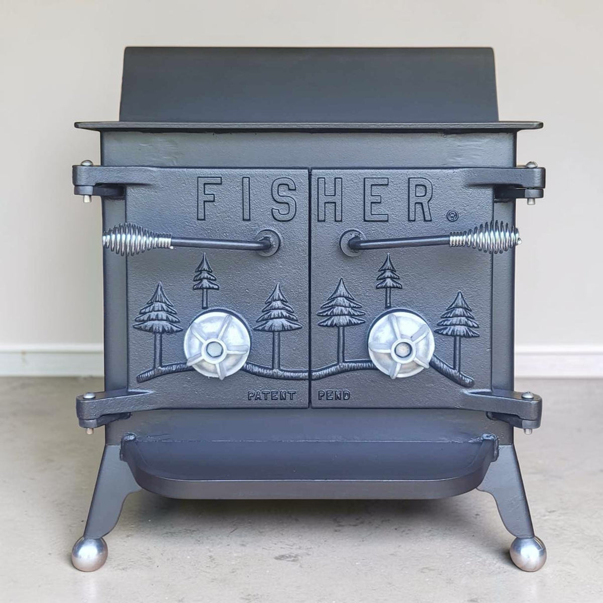Fisher Grandma Bear wood stove with rear vent and classic ball feet
