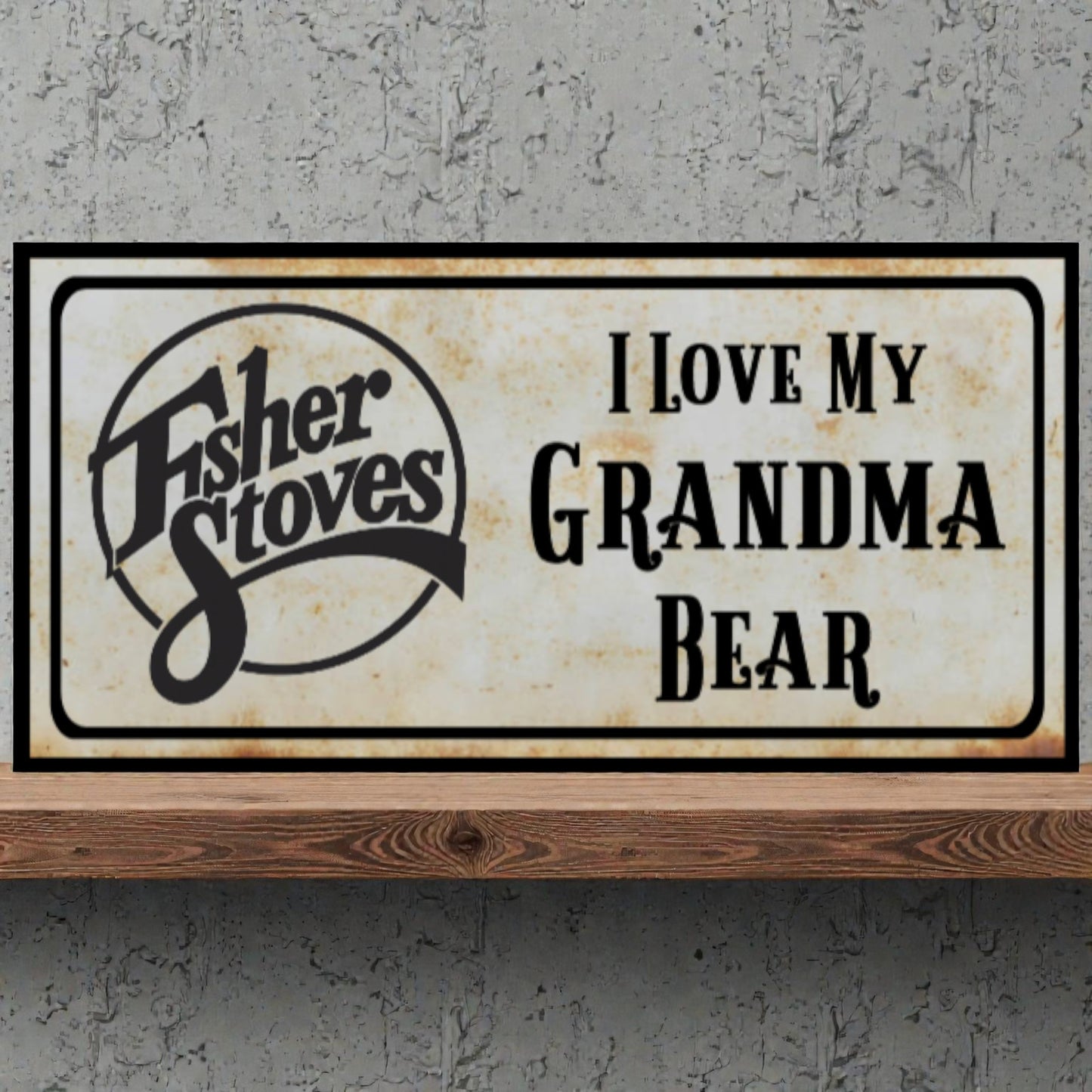 Fisher Stoves sign with 'I Love My Grandma Bear' text on a concrete wall.