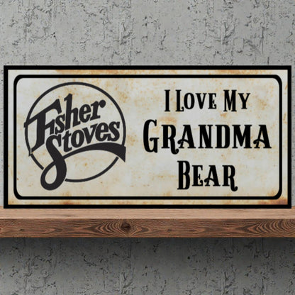 Fisher Stoves sign with 'I Love My Grandma Bear' text on a concrete wall.