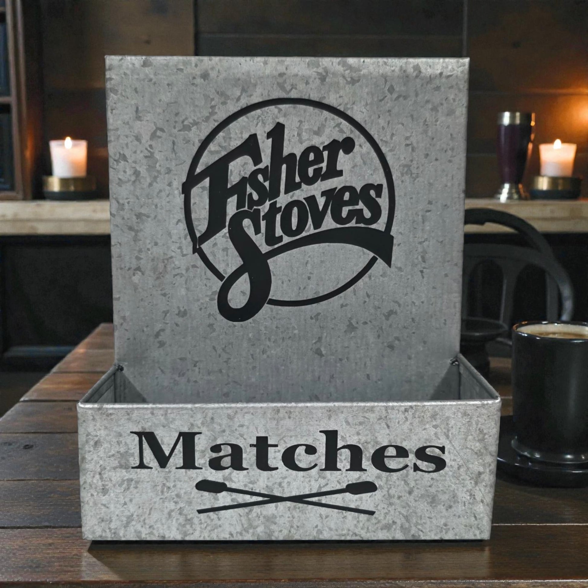 Matches box with Fisher Stoves logo on a wooden surface