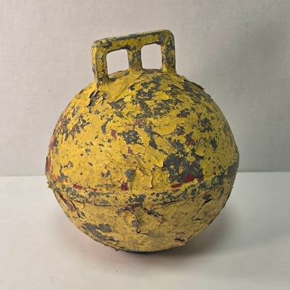 Antique yellow Newfoundland fishing buoy stamped Phillips Trawl Products Ltd., Grimsby England.