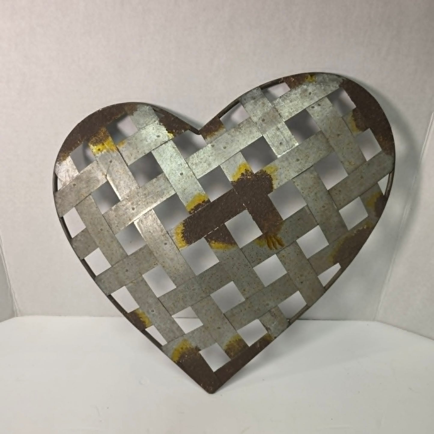 Rustic woven galvanized metal folk art heart wall hanging.