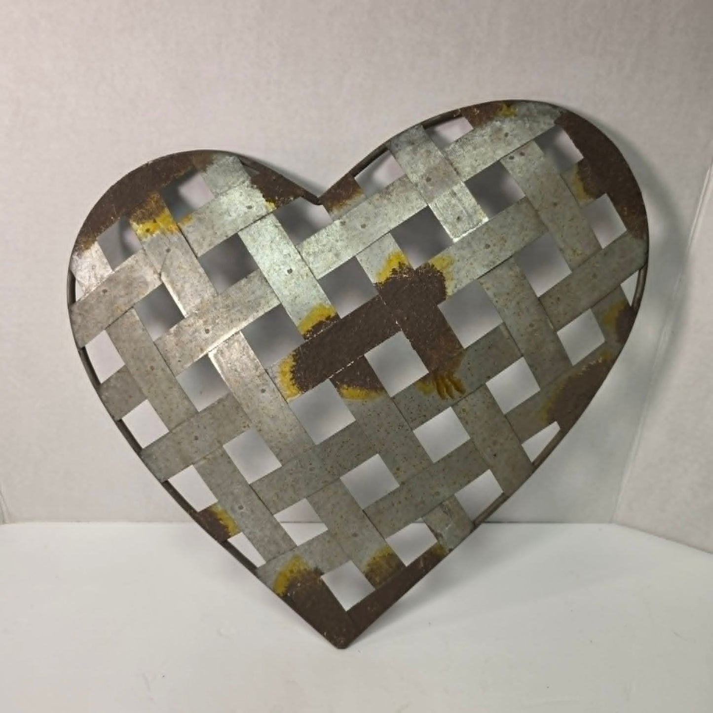 Rustic woven galvanized metal folk art heart wall hanging.