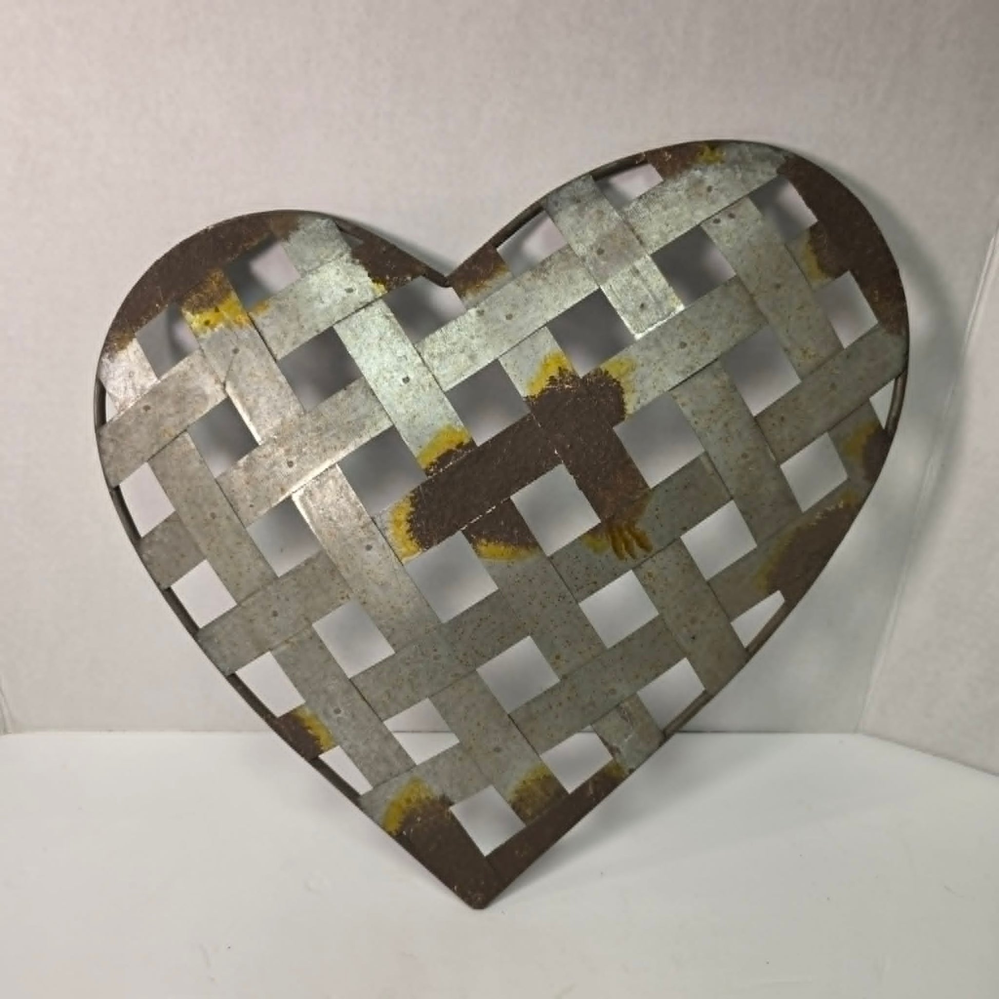 Rustic woven galvanized metal folk art heart wall hanging.