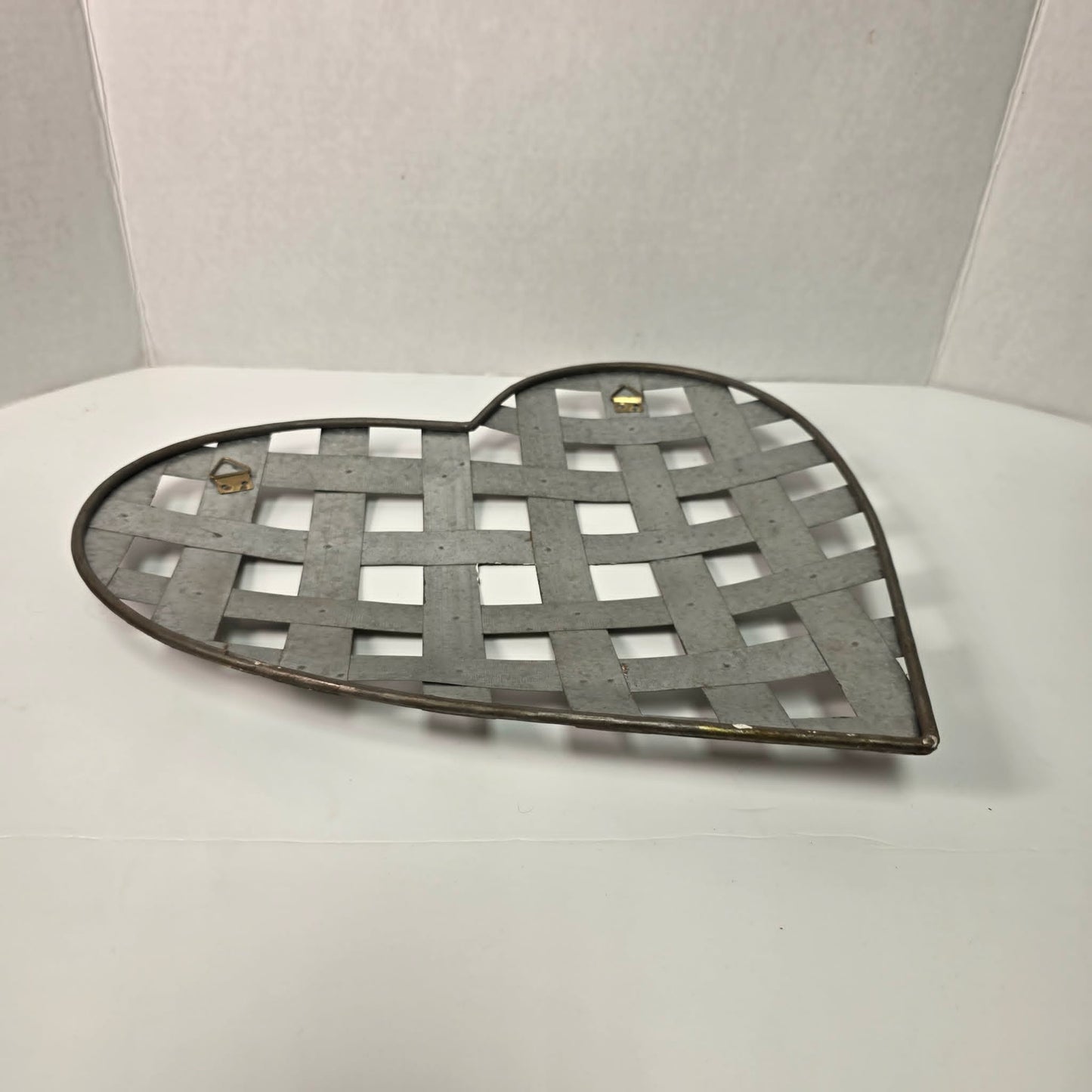 Rustic woven galvanized metal folk art heart wall hanging.