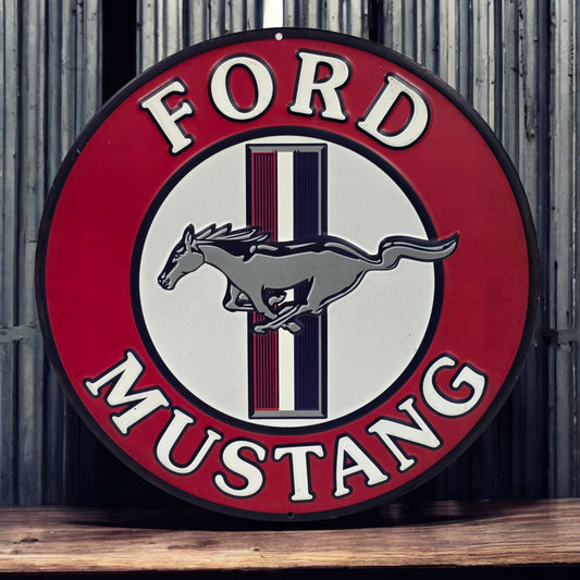 Ford Mustang logo on a round sign with a red border and wooden surface below