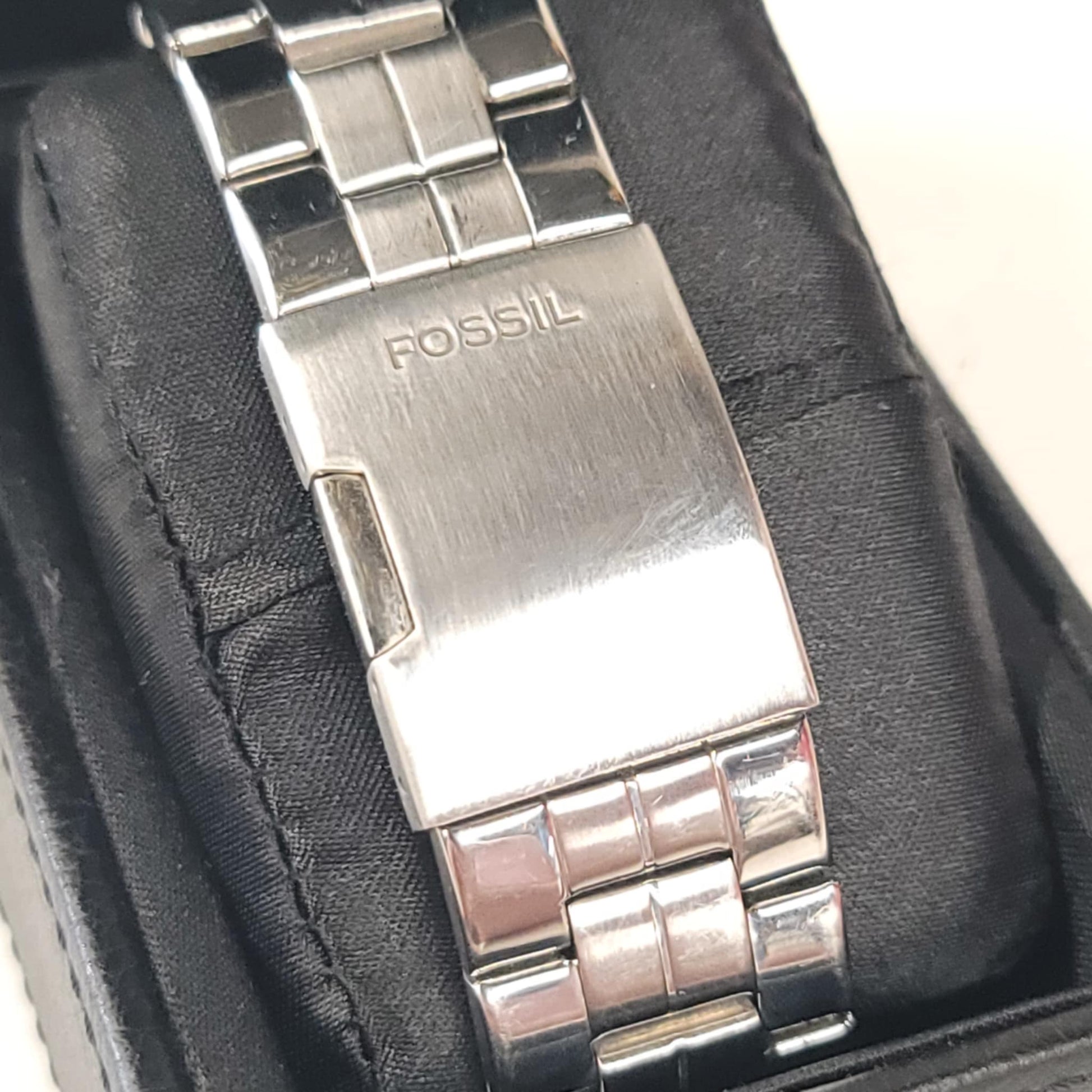Close-up of a Fossil watch band in a black box