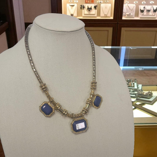 Necklace with blue stones on a mannequin bust in a jewelry store setting