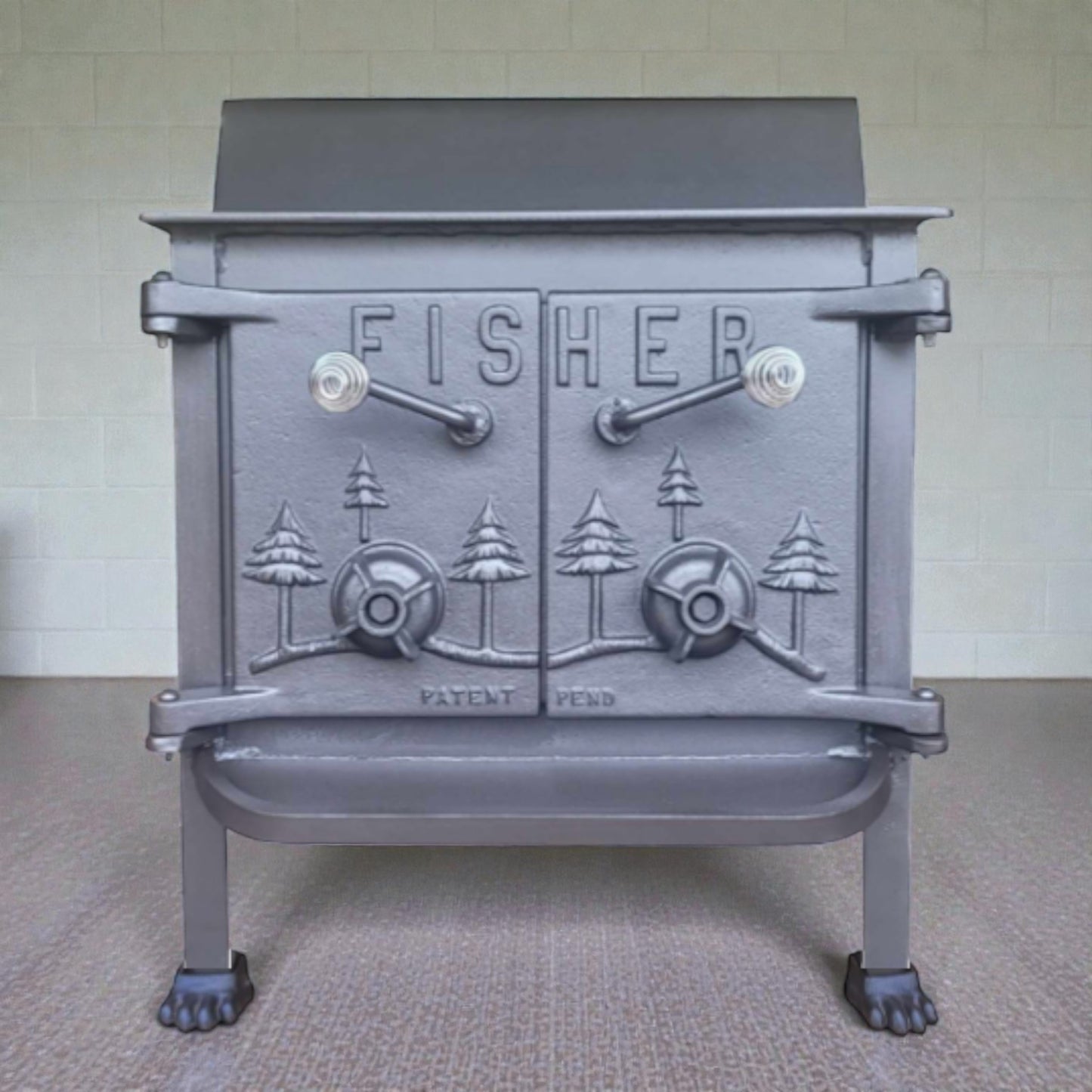 Gray cast iron stove with 'Fisher' branding on a neutral background
