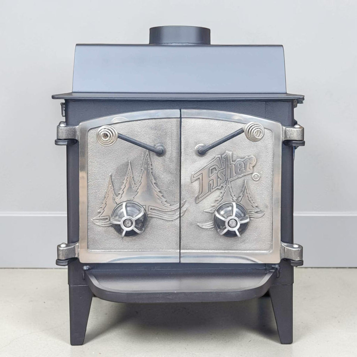 Vintage Fisher Grandma Bear wood stove with full nickel cathedral doors and top chimney vent.
