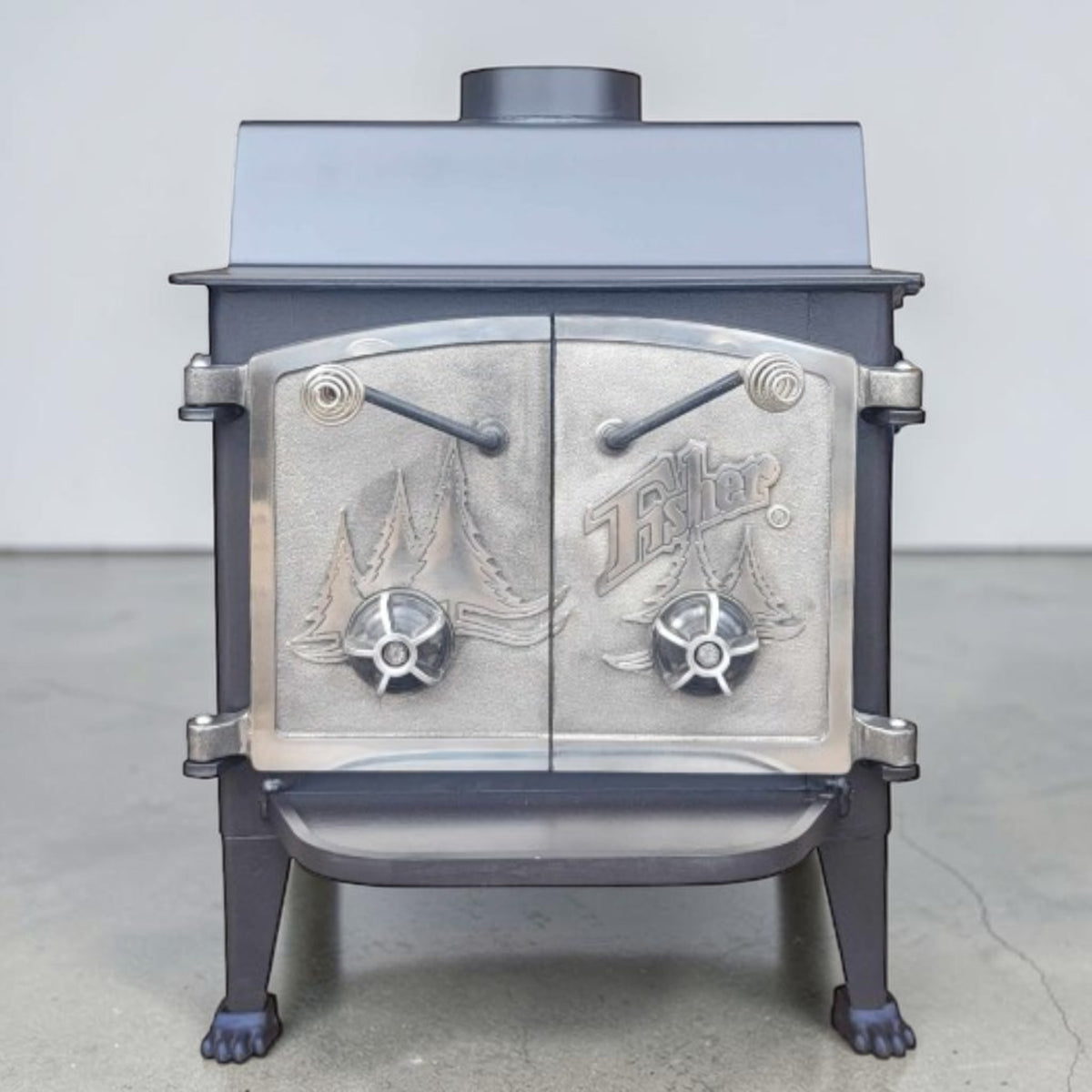 Vintage Fisher Grandma Bear wood stove with full nickel cathedral doors and top chimney vent.
