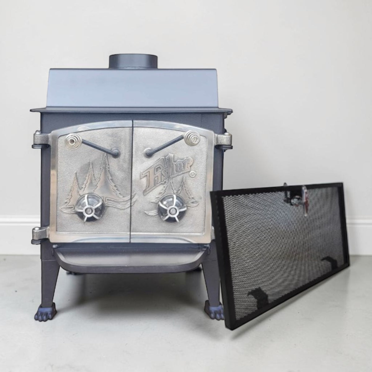 Vintage Fisher Grandma Bear wood stove with full nickel cathedral doors and top chimney vent.
