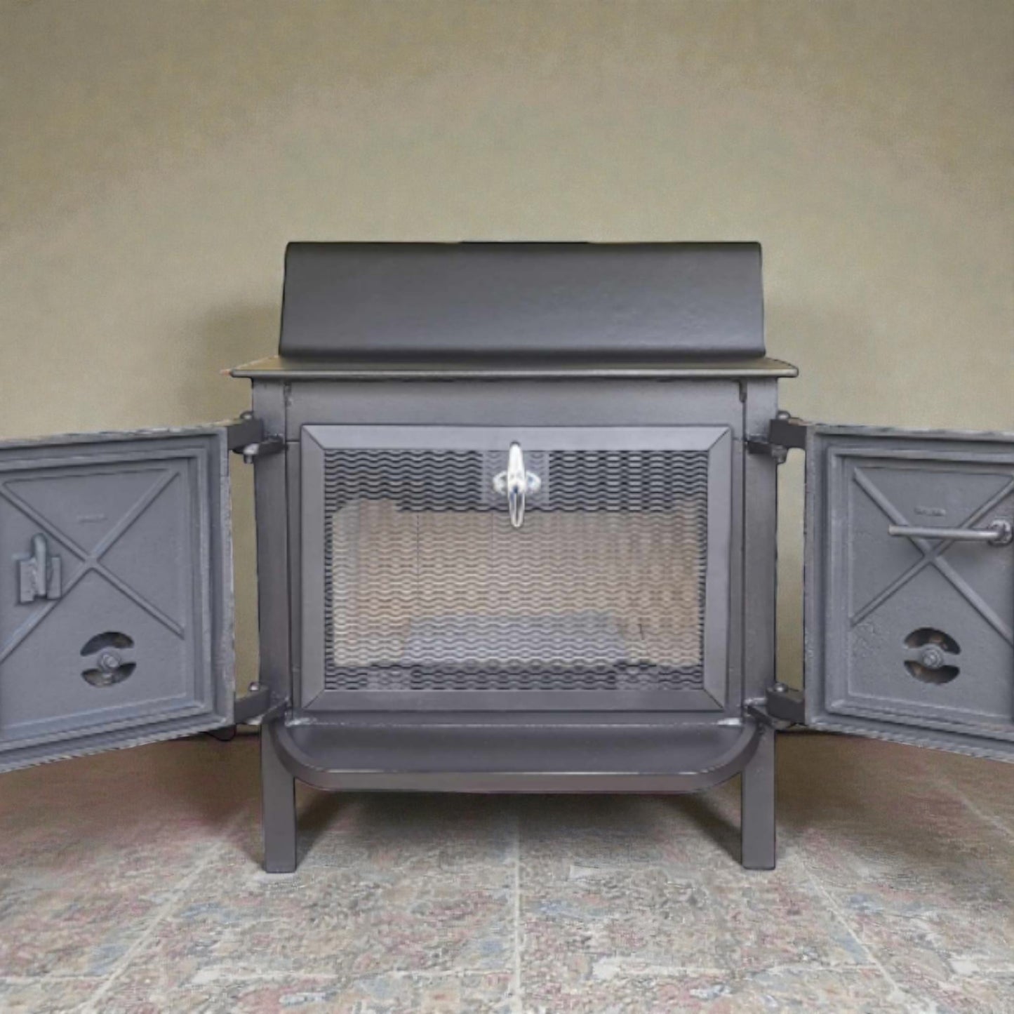 Gray metal stove with open doors on a tiled floor against a beige wall.