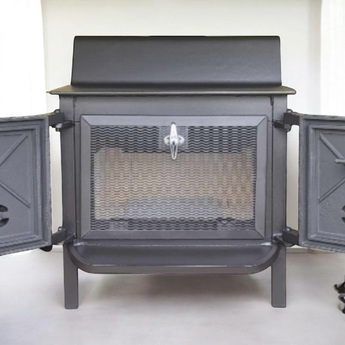 Fisher Grandma Bear wood stove with rear vent chimney and optional cooking surface.
