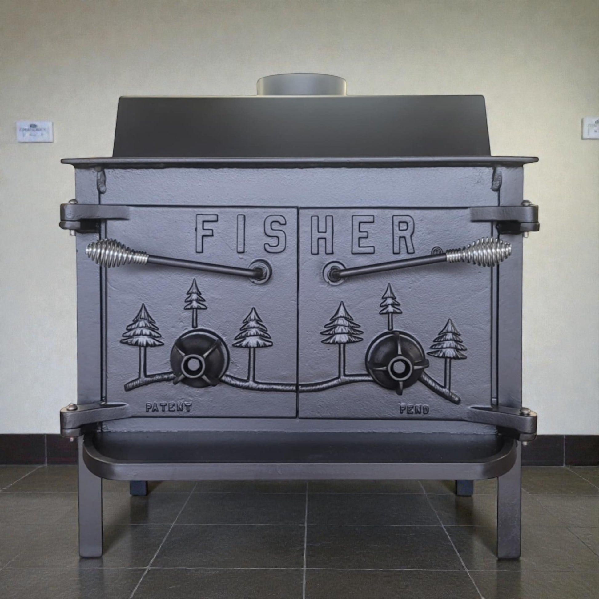 Cast iron stove with 'Fisher' branding on a tiled floor.