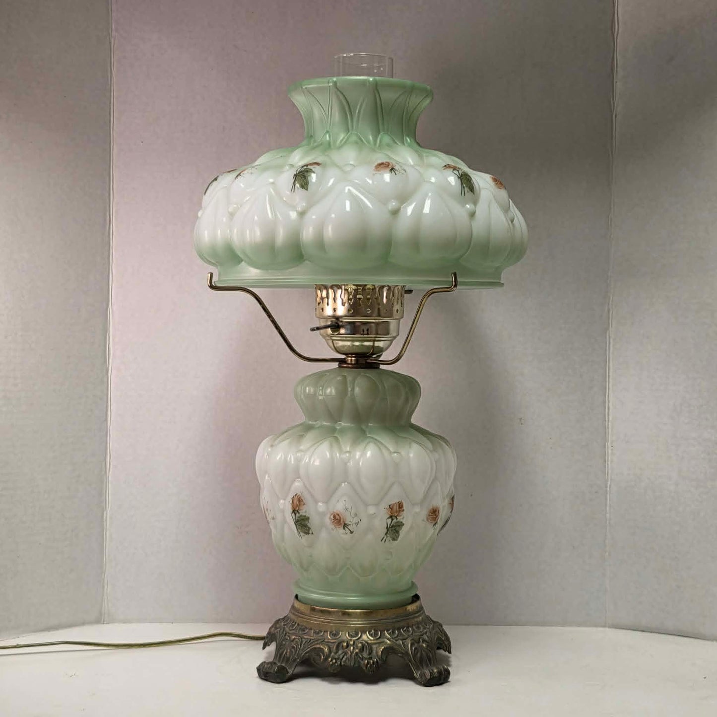 A beautiful vintage pastel green floral tri-light hurricane lamp offering classic elegance and a warm glow for any room.