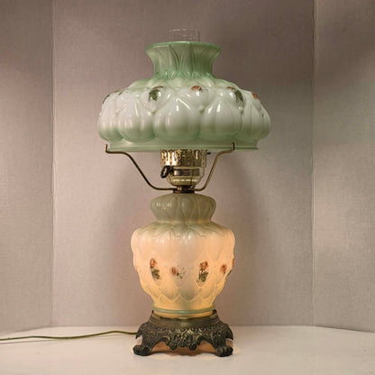 A beautiful vintage pastel green floral tri-light hurricane lamp offering classic elegance and a warm glow for any room.