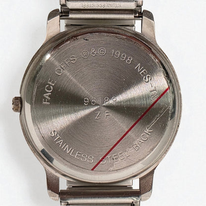 Back view of a stainless steel watch with engraved text on a white background