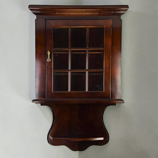 Vintage deep mahogany corner hanging cupboard with glazed glass door, brass teardrop knob, and interior shelves.