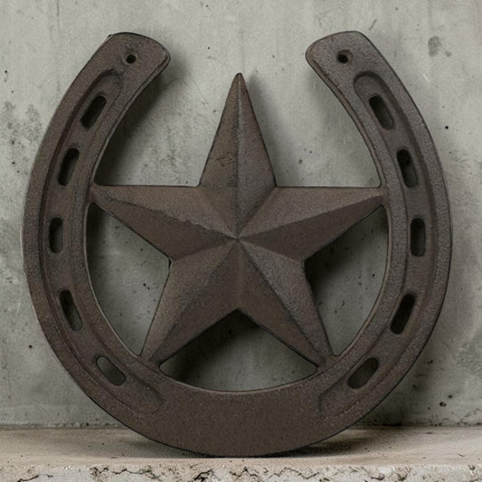 Decorative metal horseshoe with star design on a concrete surface