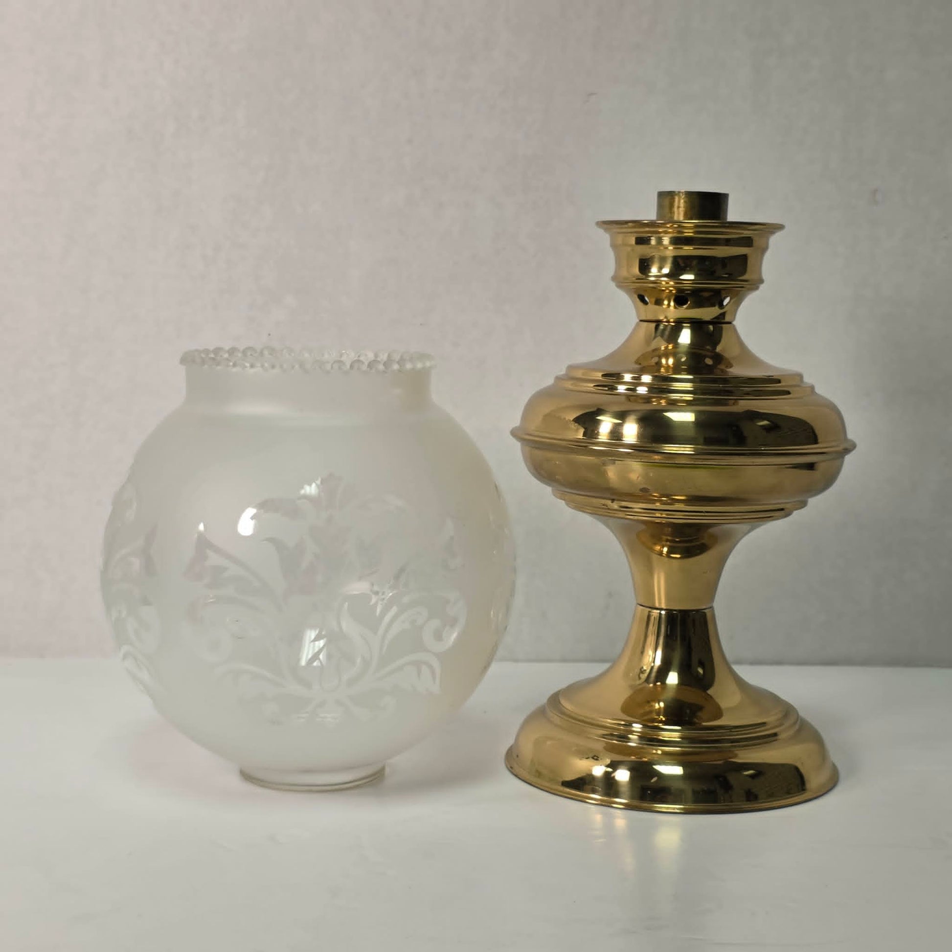 Vintage brass hurricane candle holder with elegant etched glass globe.