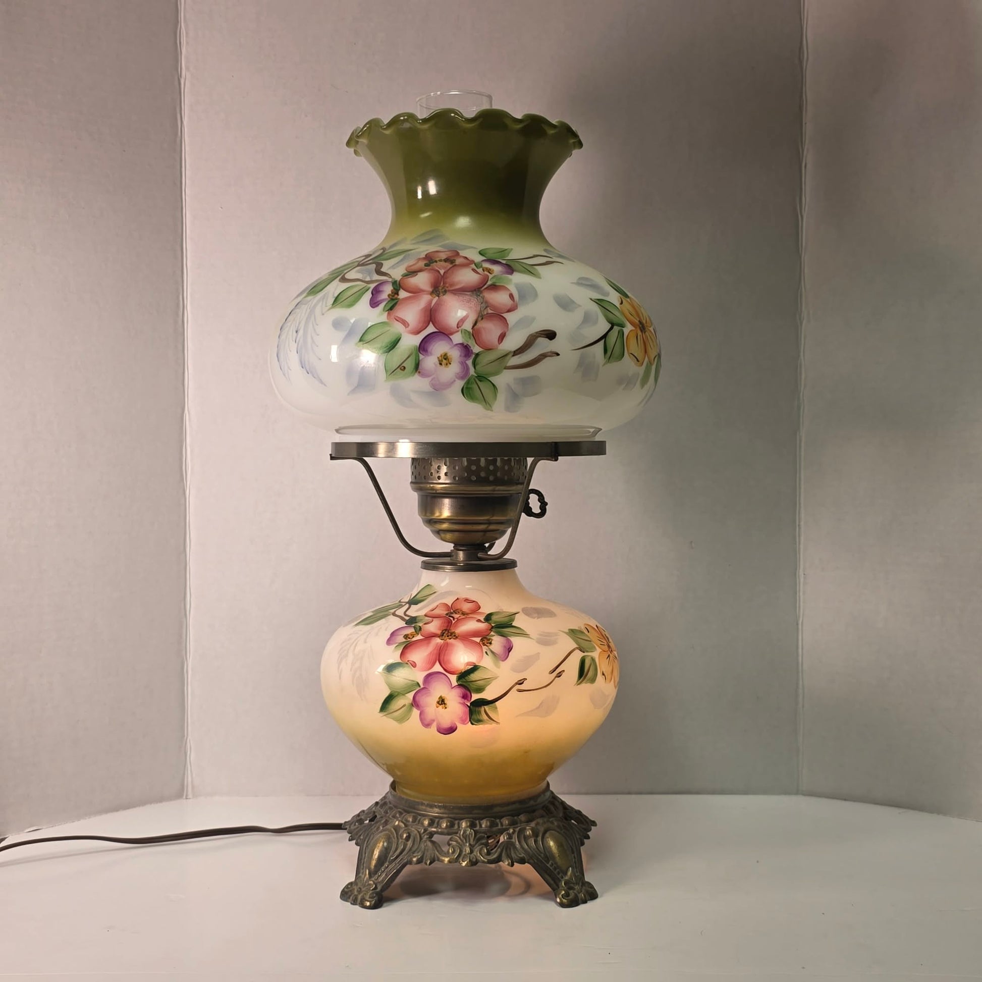 Vintage hurricane lamp with pastel hand-painted floral glass and dual lighting feature.