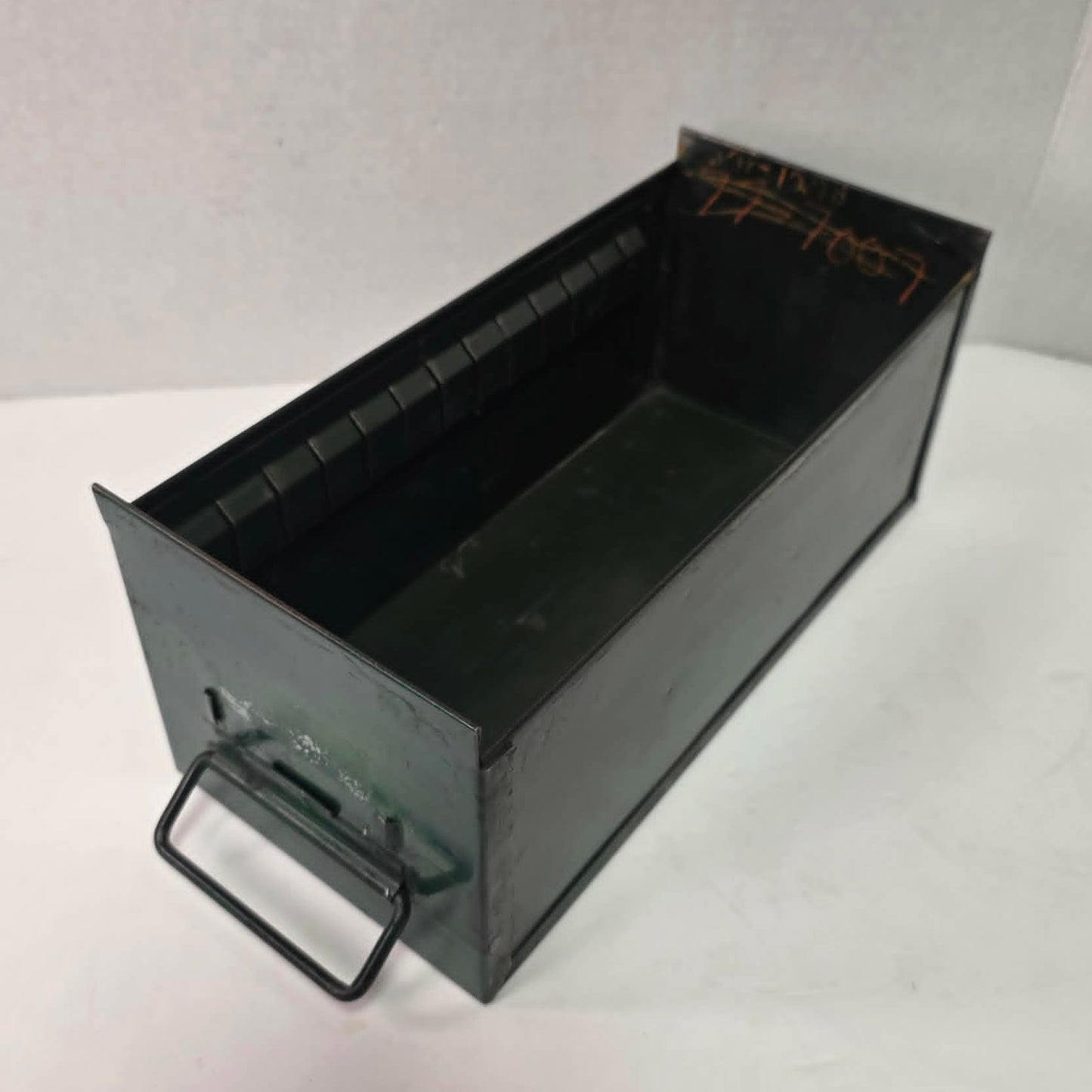 Antique industrial apothecary drawer with bail handle and label holder, vintage storage bin with aged patina.